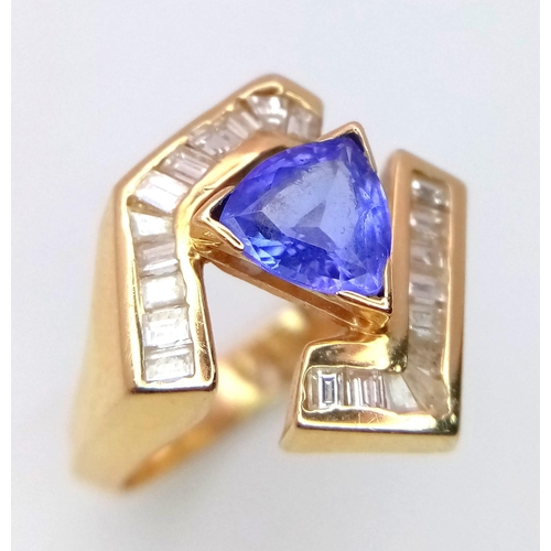 683 - A Futuristic 14k Yellow Gold and Blue Topaz Ring. A trillion cut topaz between two arms of diamonds.... 