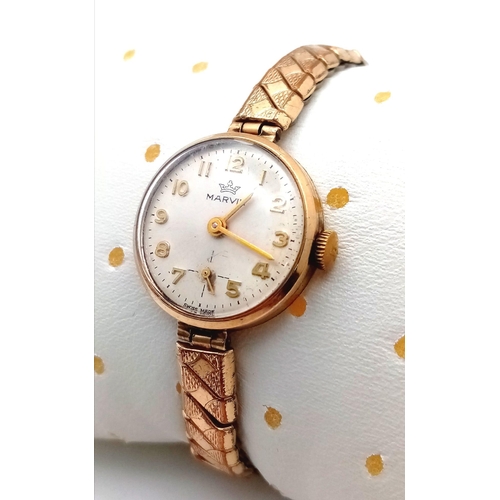 310 - A Vintage 9K Gold Cased Marvin Ladies Watch. Expandable gilded bracelet. 9K gold case - 21mm. White ... 