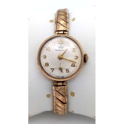 310 - A Vintage 9K Gold Cased Marvin Ladies Watch. Expandable gilded bracelet. 9K gold case - 21mm. White ... 