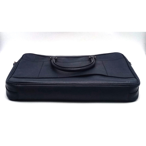 270 - A Prada Saffiano Briefcase. Navy blue textured leather exterior. Prada logo badge. Name tag. Quality... 