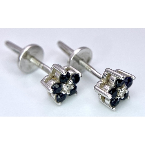 506 - A Pair of 14K White Gold, Sapphire and Diamond Stud Earrings. 1.41g total weight.