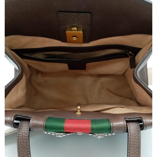 51 - A Gucci Linea Butterfly Clasp Satchel. Brown calfskin leather exterior with decorative white stone b... 