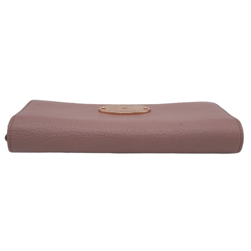 611 - A Mulberry Deep Pink Wallet. 19cm width by 9cm height. Comes with a Mulberry case. Ref: 15402