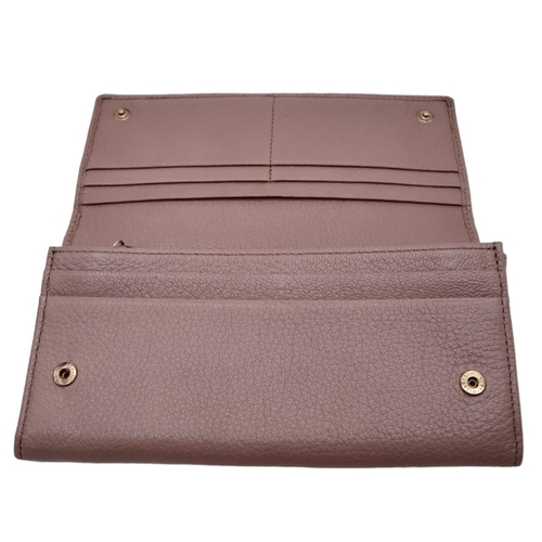 611 - A Mulberry Deep Pink Wallet. 19cm width by 9cm height. Comes with a Mulberry case. Ref: 15402