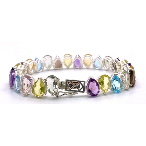 634B - A Kaleidoscopic Pear Shaped Tennis Bracelet. Amethyst, Blue Topaz, Garnet and Peridot! Set in 925 Si... 