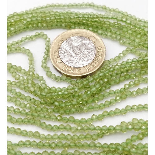 611B - A Peridot gemstone multi-strand beaded necklace with a 925 Silver clasp.
With a 140cts of Peridot ge... 