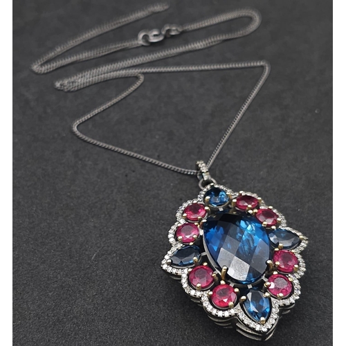 734B - This Blue Topaz, Ruby & Diamond, Sterling Silver Pendant Necklace is a jaw-dropper. 
With 30cts of B... 