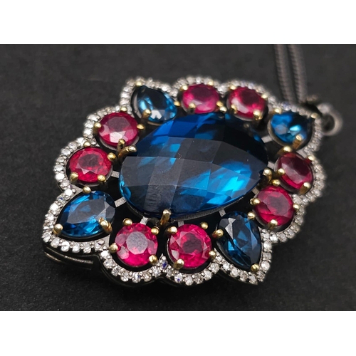 734B - This Blue Topaz, Ruby & Diamond, Sterling Silver Pendant Necklace is a jaw-dropper. 
With 30cts of B... 