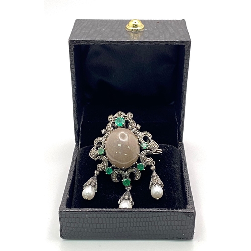 749B - A Scintillating Opal, Emerald & Diamond, Sterling Silver (tested) Brooch. The central 6.10ct opal ha... 