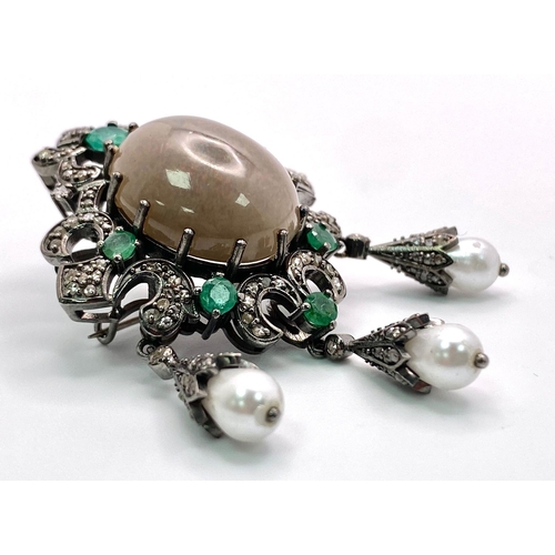 749B - A Scintillating Opal, Emerald & Diamond, Sterling Silver (tested) Brooch. The central 6.10ct opal ha... 