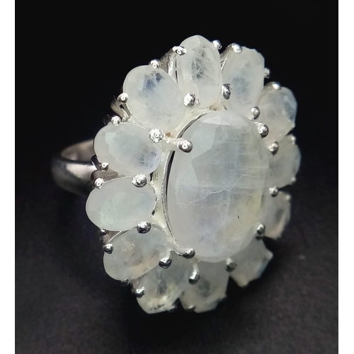 763B - An iridescent Moonstone, Sterling Silver Cocktail Ring.
Wonderful floral design that shimmers and gl... 