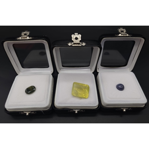 769B - Three Certificated Gemstones: 4.63ct blue tanzanite cabochon, a Madagascan 29.4ct lemon quartz and a... 