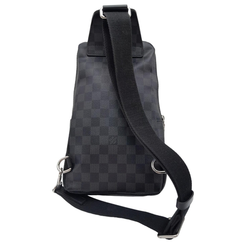 303 - A Louis Vuitton Avenue Slingbag. Checked graphite canvas exterior with zipped compartment. Silver to... 