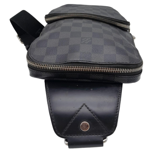 303 - A Louis Vuitton Avenue Slingbag. Checked graphite canvas exterior with zipped compartment. Silver to... 