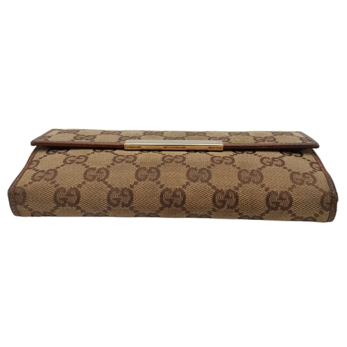 555 - A Classic Gucci Monogram Wallet. Comes with case and receipt. 19cm x 10cm. Ref: 15396