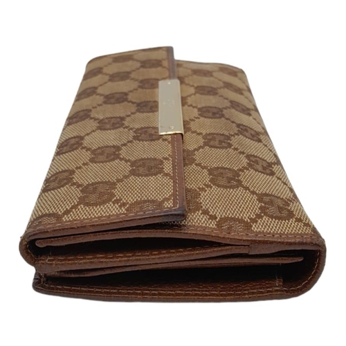 555 - A Classic Gucci Monogram Wallet. Comes with case and receipt. 19cm x 10cm. Ref: 15396