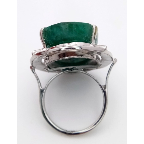 784B - An Oval Cut 35ct Emerald and 925 Sterling Silver Ring. 18.8g total weight. Size R. 18.77g total weig... 