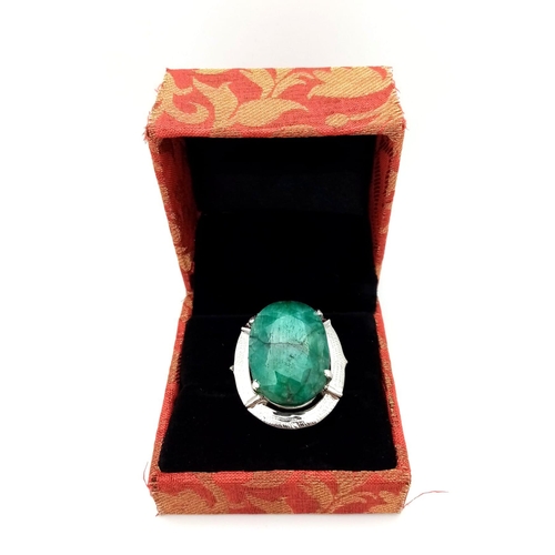 784B - An Oval Cut 35ct Emerald and 925 Sterling Silver Ring. 18.8g total weight. Size R. 18.77g total weig... 