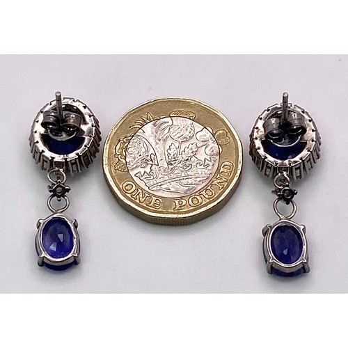 695B - Delightful pair of Blue Sapphire and Diamond, Sterling Silver Drop Earrings.
11.70ctw of Blue Sapphi... 