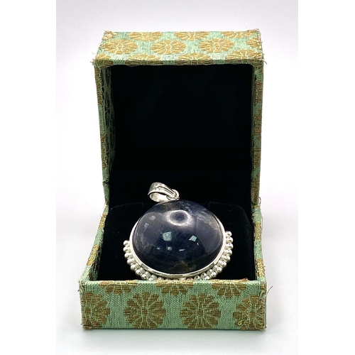 716B - A 166.5ct Huge Blue Sapphire Cabochon 925 Silver Pendant. 66.55ct. W- 42g. 5.5cm. Comes with a prese... 