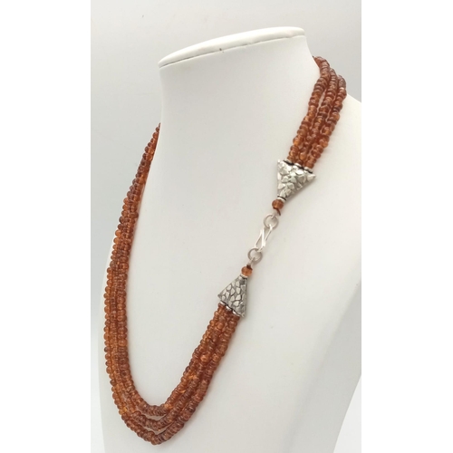 676B - A Three-Row Hessonite Garnet Natural Gemstone Beaded Necklace. 250ct. 925 Silver Clasp. 44cm. Comes ... 