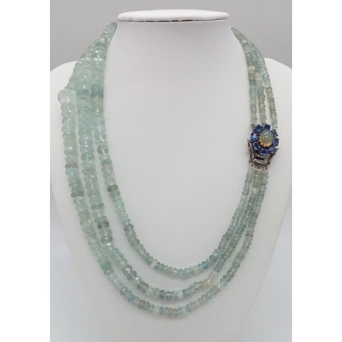 765B - An Aquamarine Three Strand Graduated Bead Necklace. Opal and Kyanite Halo Clasp. Aquamarines - 422ct... 