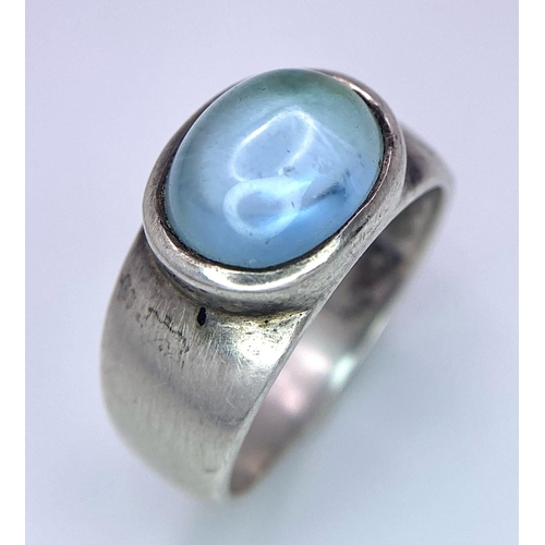 740B - A 925 Silver Ring, with central blue stone.
Size: N
Weight: 5.22g