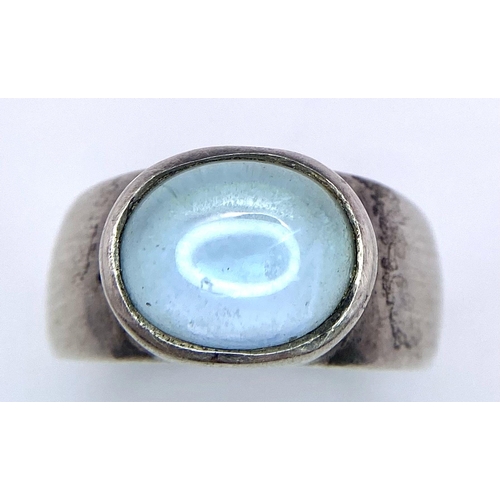 740B - A 925 Silver Ring, with central blue stone.
Size: N
Weight: 5.22g