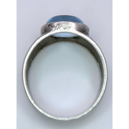 740B - A 925 Silver Ring, with central blue stone.
Size: N
Weight: 5.22g