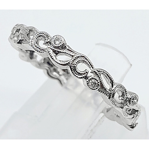 731B - A 9KT White Gold, Diamond Set Ring.
With unique, scrolling design.
Size: L
Weight: 1.92g