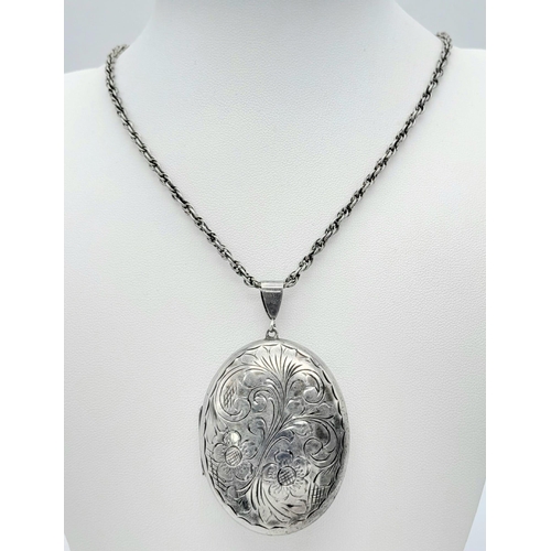 548 - A vintage sterling silver cosmetic mirror pendant with flower motif on silver chain. Full Birmingham... 