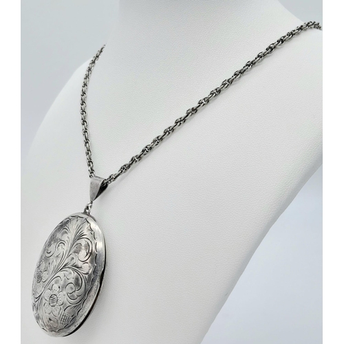 548 - A vintage sterling silver cosmetic mirror pendant with flower motif on silver chain. Full Birmingham... 