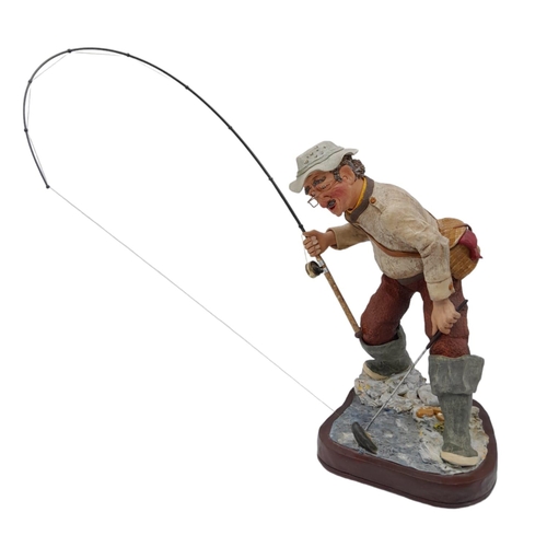 394 - A Hand-Made Colin George Fisherman Sculpture. 26cm tall plus rod! Comes with a signed photo.