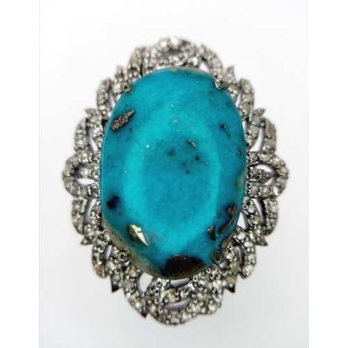 834B - A wonderful 18ct Turquoise, Sterling Silver Ring.
The central stone is surrounded by Diamonds, 0.8ct... 