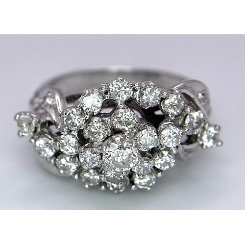 938B - A Fancy Cluster Ring - Set with 1.1ctw of round cut diamonds. Set in white metal. Size O