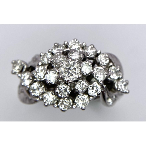 938B - A Fancy Cluster Ring - Set with 1.1ctw of round cut diamonds. Set in white metal. Size O