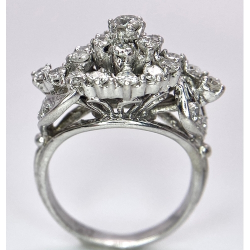 938B - A Fancy Cluster Ring - Set with 1.1ctw of round cut diamonds. Set in white metal. Size O