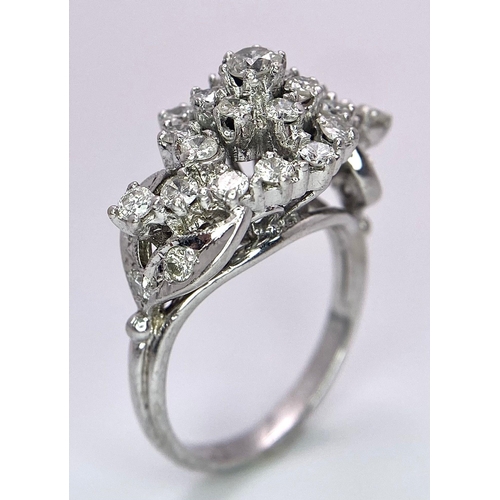 938B - A Fancy Cluster Ring - Set with 1.1ctw of round cut diamonds. Set in white metal. Size O