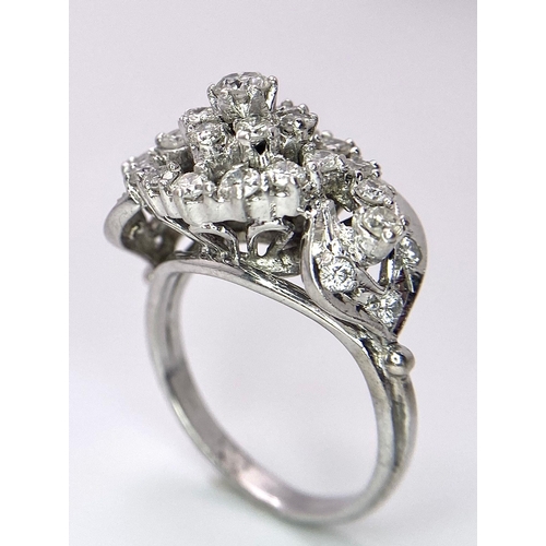 938B - A Fancy Cluster Ring - Set with 1.1ctw of round cut diamonds. Set in white metal. Size O