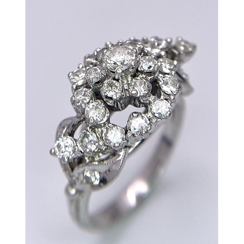 938B - A Fancy Cluster Ring - Set with 1.1ctw of round cut diamonds. Set in white metal. Size O