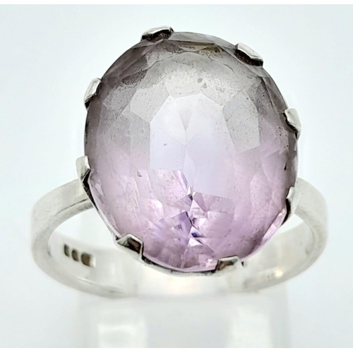 311 - A vintage sterling silver faceted Amethyst solitaire ring. Total weight 4.4G. Size O.