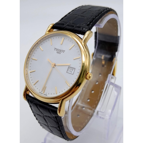 43 - An 18K Gold Cased Tissot Carson Quartz Gents Watch. Original black leather strap. 18K gold case - 34... 