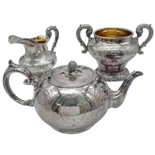 660 - A Three-Piece Antique Silver Plated Tea Set. Includes a teapot, creamer and sugar bowl - with gilded... 