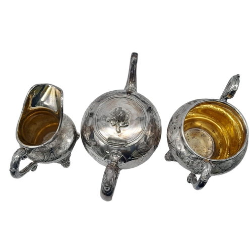 660 - A Three-Piece Antique Silver Plated Tea Set. Includes a teapot, creamer and sugar bowl - with gilded... 