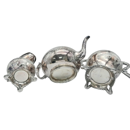 660 - A Three-Piece Antique Silver Plated Tea Set. Includes a teapot, creamer and sugar bowl - with gilded... 