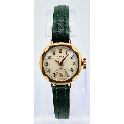 685B - A Vintage Omer 9K Gold Cased Ladies Watch. New green leather strap. 9K gold case - 21mm. White dial ... 