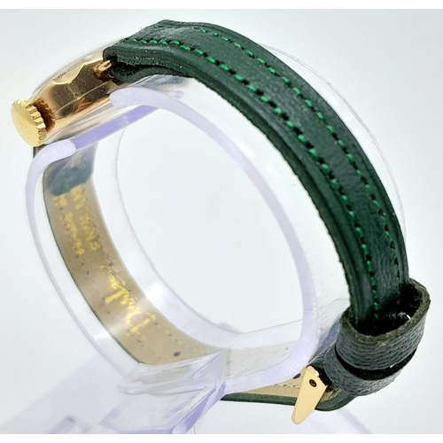 685B - A Vintage Omer 9K Gold Cased Ladies Watch. New green leather strap. 9K gold case - 21mm. White dial ... 