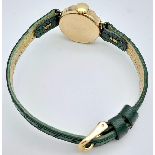 685B - A Vintage Omer 9K Gold Cased Ladies Watch. New green leather strap. 9K gold case - 21mm. White dial ... 