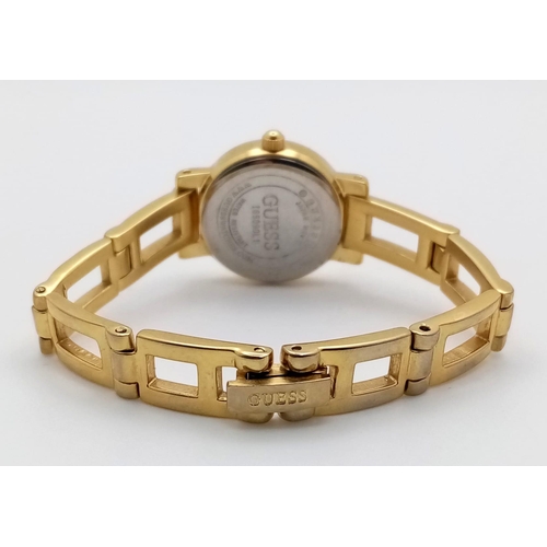 850B - A Fashionable Gold Plated Guess Quartz Ladies Watch. Gilded bracelet and case - 20mm. Gilded dial. I... 