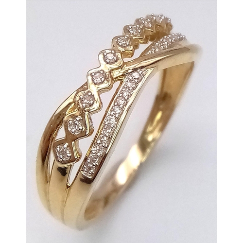 1571 - A 9K YELLOW GOLD 2 ROW DIAMOND TWIST CROSS OVER RING. TOTAL WEIGHT 2.4G. SIZE P